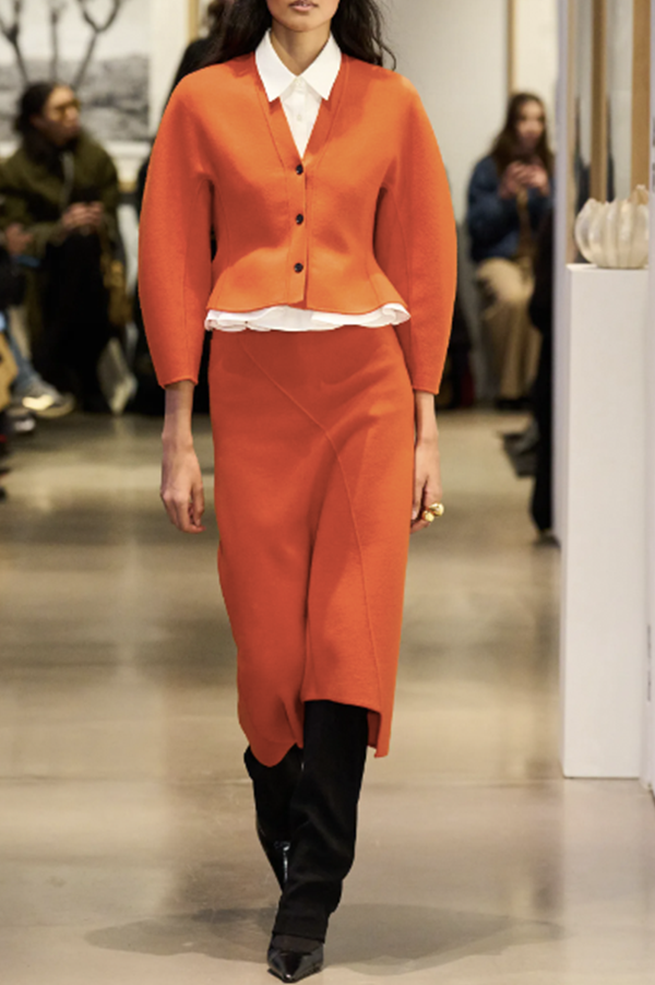 A-line 'Felix' skirt. Ashlyn skirt. Ashlyn soft merino wool. Ashlyn knit. Ashlyn Fall 2025, Ashlyn asymmetric paneled detailing. orange hued. Luxurious knit. Persimmon skirt. Tangerine skirt. Des Kohan Ashlyn. Des Kohan Fairfax Ashlyn. Ashlyn West Hollwood. Ashlyn exclusives. 