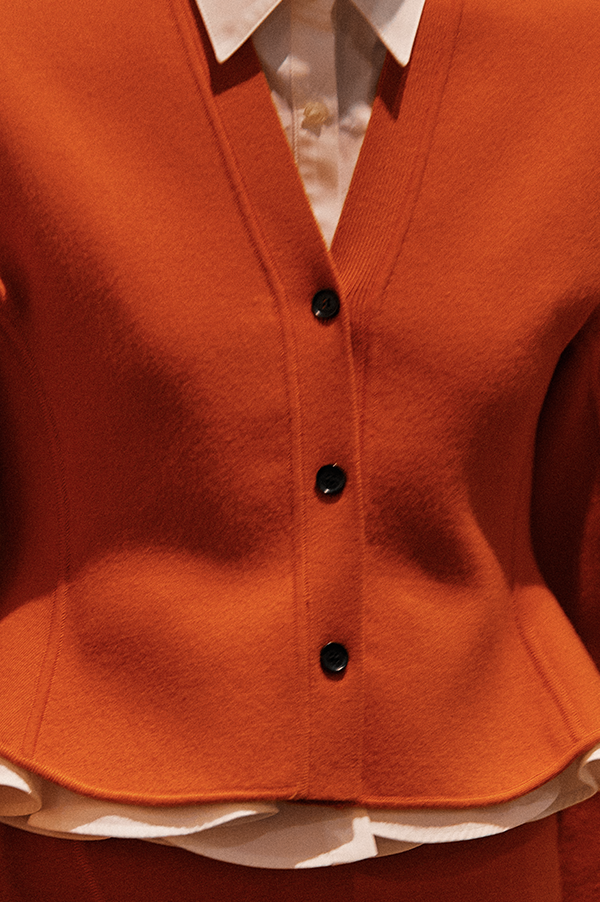 Ashlyn Henry Cardigan. Ashlyn cardigan with peplum. Ashlyn soft merino wool. Ashlyn knit. Ashlyn Fall 2025, Ashlyn sweater. orange hued. Luxurious knit. Persimmon cardigan. Tangerine cardigan. Des Kohan Ashlyn. Des Kohan Fairfax Ashlyn. Ashlyn West Hollwood. Ashlyn exclusives. 