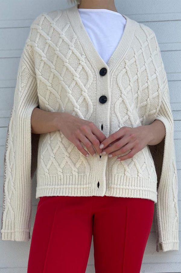 Maria McManus Twisted Cable Cardigan Stone. Maria McManus Cardigan Cream. Maria McManus Twisted Cable Cardigan in Ivory. Maria McManus Ivory/Cream cardigan. Maria McManus fine merino wool Cardigan. Maria McManus Oversized Fit cardigan. Maria McManus Oversized Cream/Ivory sweater. Maria McManus sweater chunky stich cable. Ivory Chunky Cardigan. Cream Cable knit sweater. Maria McManus Cable knit sweater. Maria McManus two tone cardigan.Dark Horn button closure.Maria McManus cape arm cardigan.Ivory Taupe twist